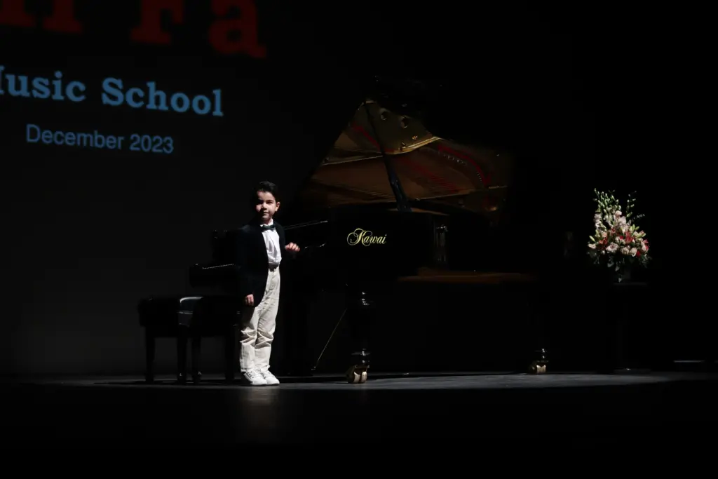 A child who participated in the Mifa Music School performance after attending piano classes