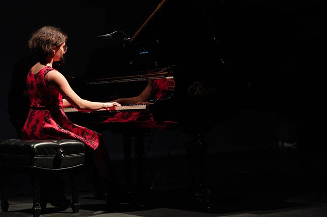 A girl playing the piano at a Mifa Music School performance in North Vancouver