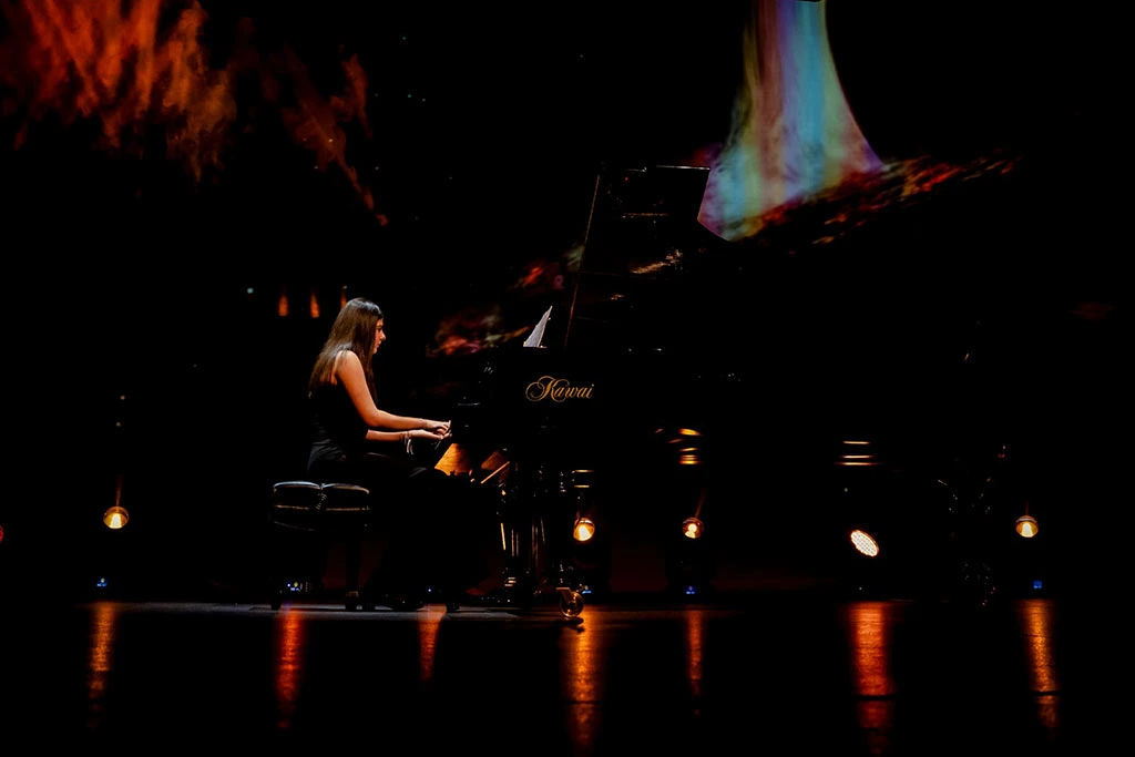 student at MiFa Music School playing the piano